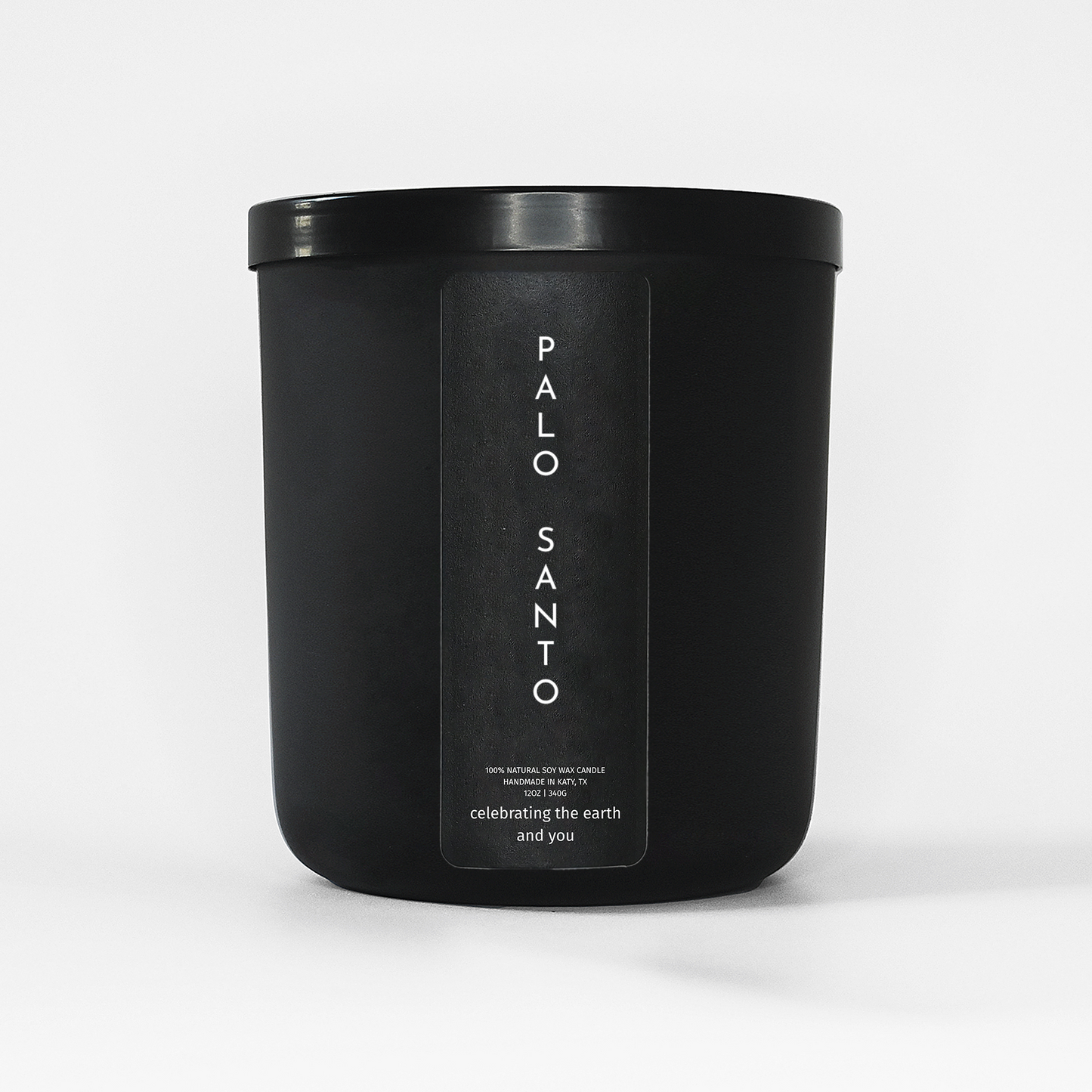 Black candle jar labeled 'Palo Santo' on a white background