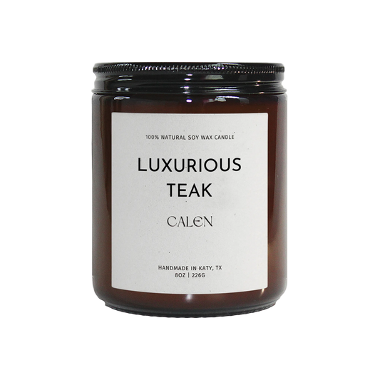 Candle labeled 'Luxurious Teak' by 'Calen' on a white background