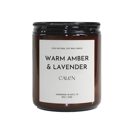 Candle with 'Warm Amber & Lavender' label on a white background