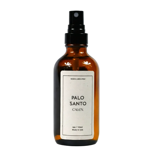 Brown spray bottle labeled 'Palo Santo Calen' on a white background