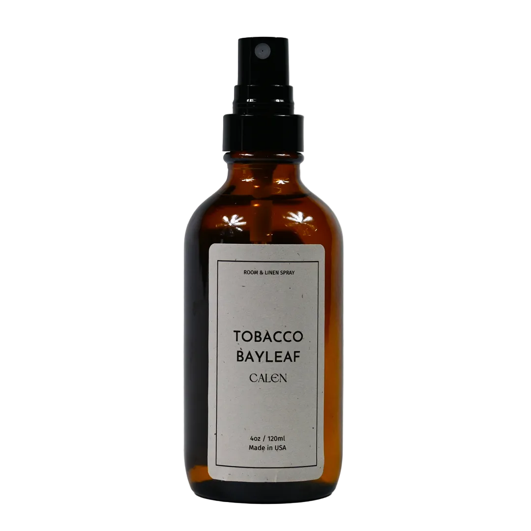 A brown glass bottle with a black spray nozzle, labeled 'TOBACCO BAYLEAF CALEN' indicating the scent and brand.