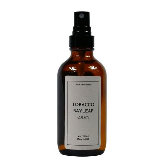 A brown glass bottle with a black spray nozzle, labeled 'TOBACCO BAYLEAF CALEN' indicating the scent and brand.